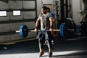 Man working out and being active in CrossFit gym